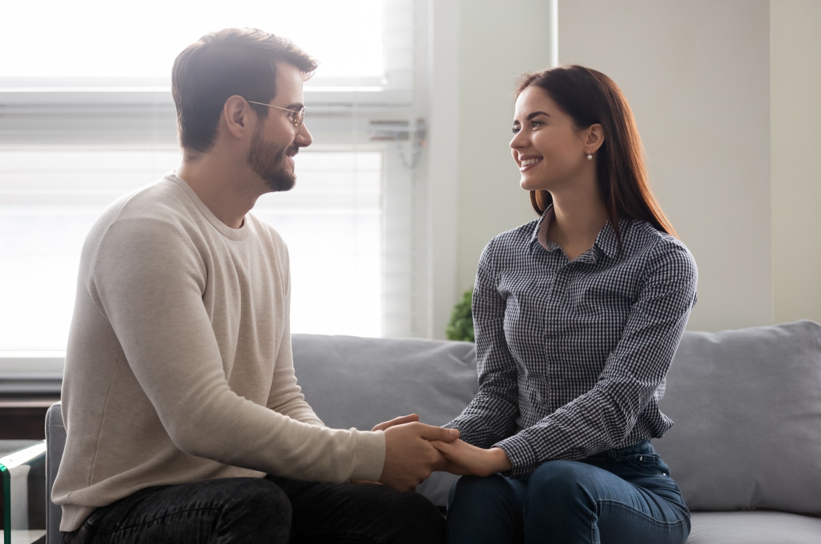 man holding woman's hands