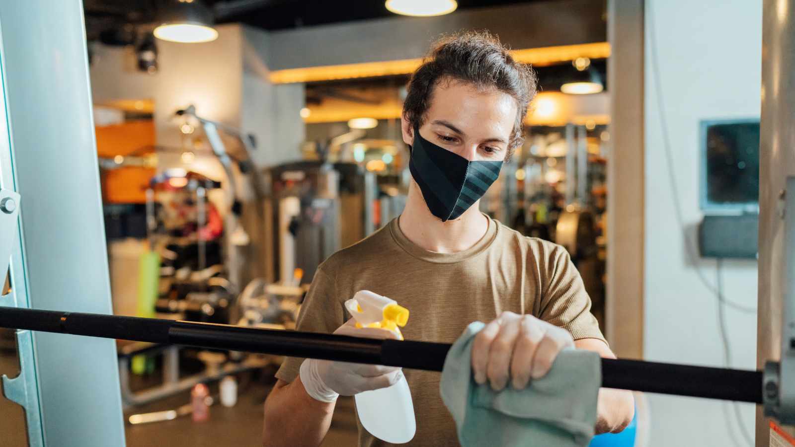 Lady cleaning gym equipment